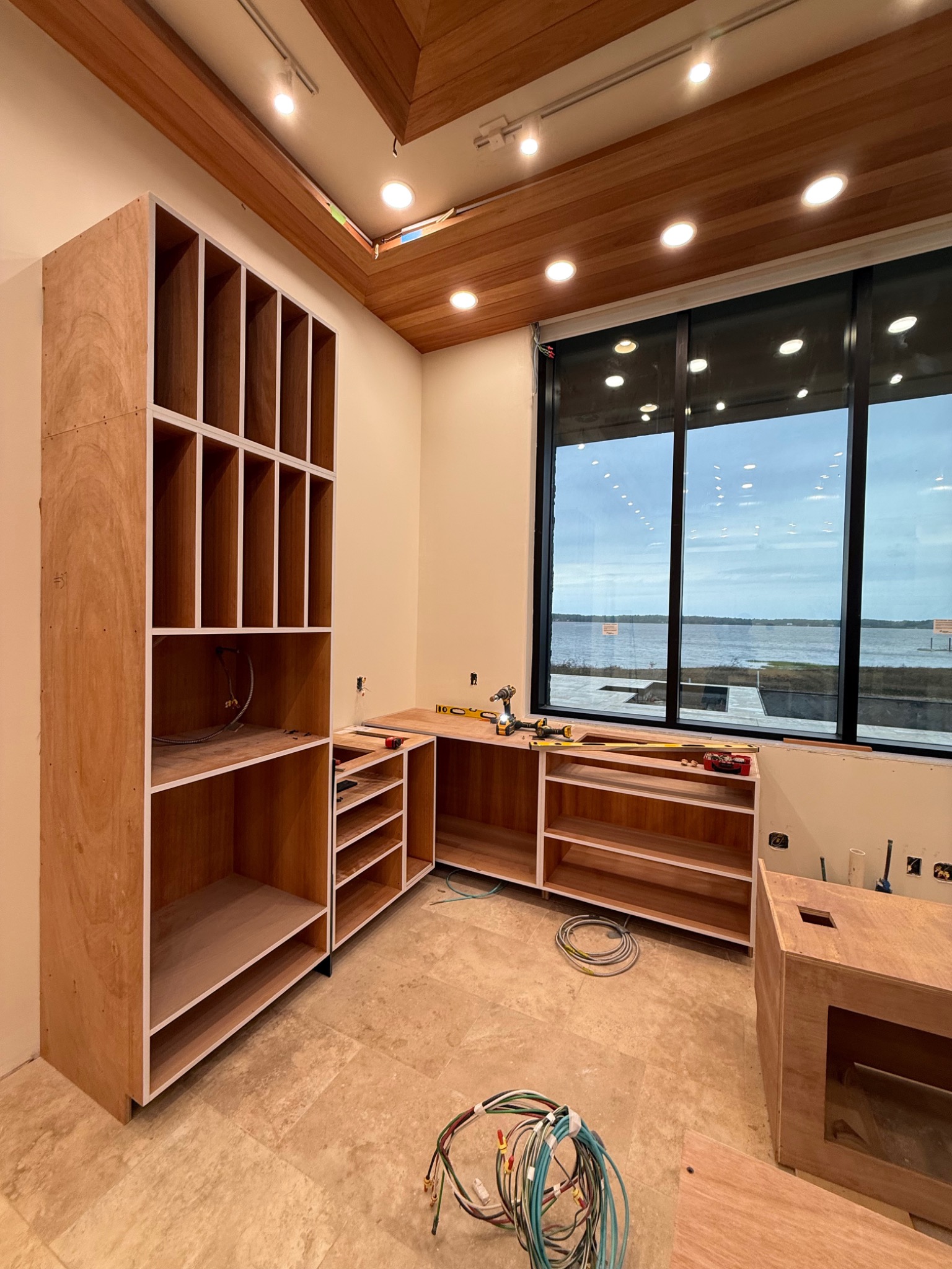 Custom cabinetry under an architectural wood ceiling